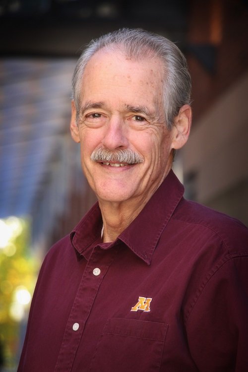 man with a mustache smiling