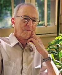 man in a white shirt leaning on his hand