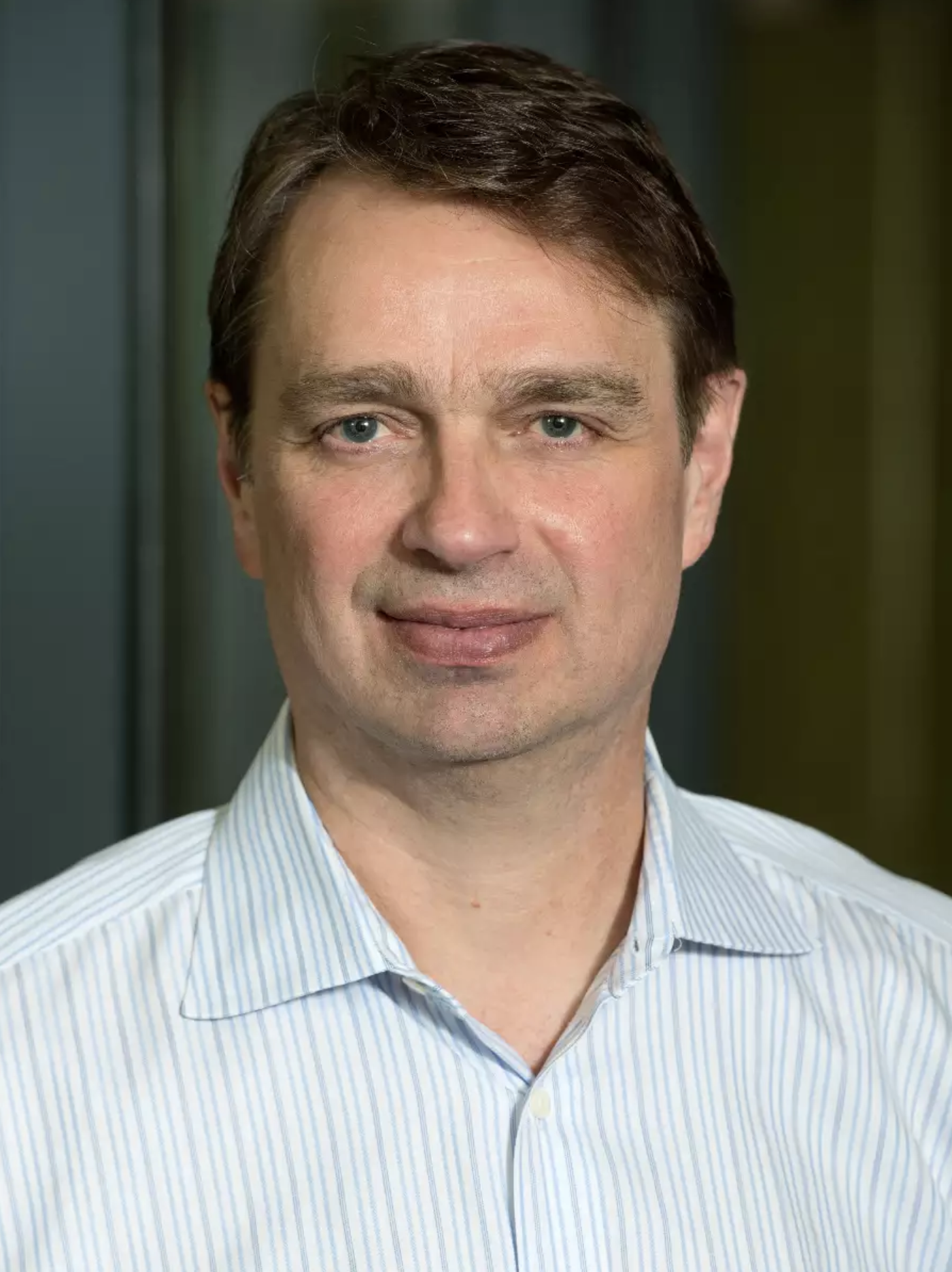 Man with dark hair and blue shirt