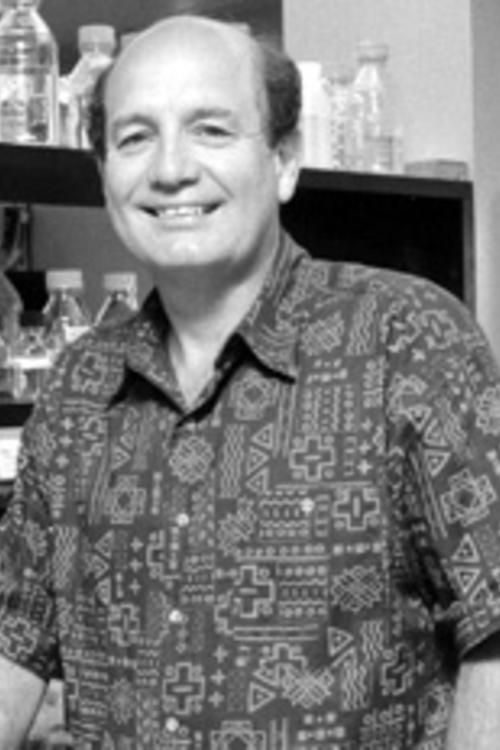 black and white photo of a man with a patterned shirt