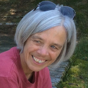 Woman with a pink shirt smiling